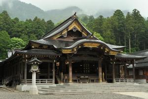 a large building with a roof and stairs in front at Minoya in Yahiko