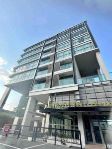 a tall building with balconies on the side of it at Lovely condo with swimming pool. in Bang Sare