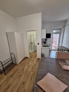 a living room with white walls and a wooden floor at Apartma Koper2 with parking in Koper +1 photo