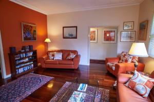 a living room with two couches and a table at Asrama Albany in Albany