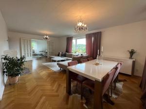 a large living room with a table and a couch at Grand villa with great location! in Gothenburg