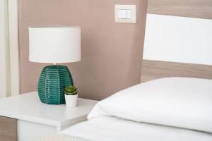 Postel nebo postele na pokoji v ubytování Portosalvo Rooms
