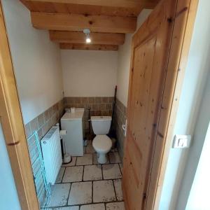 a bathroom with a toilet and a sink at Equi'val in Le Tholy