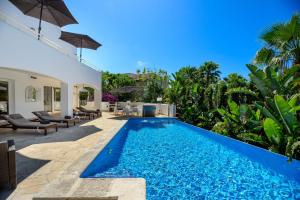 a swimming pool in the backyard of a villa at Villa Amarantos in Santa Eularia des Riu