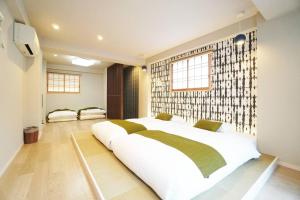 a bedroom with a large white bed in a room at Estate Kuromon Bekkan E in Osaka