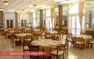 a banquet hall with tables and chairs and windows at Ramada Suites By Wyndham Solo in Solo