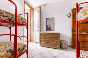 a room with two bunk beds and a desk at Villa Margherita in Geremeas