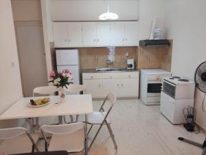 a kitchen with a table with a bowl of fruit on it at KARYSTOS City Center in Karistos
