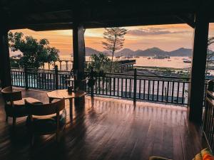 a room with a balcony with a view of the water at Cool Breeze Authentic Hotel Labuan Bajo Komodo in Labuan Bajo