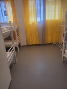 a room with bunk beds and a yellow curtain at ALBERGUE de Caldas de Reis URRACA in Caldas de Reis