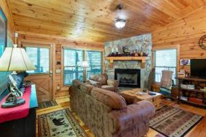 a living room with a couch and a fireplace at Mountain Spirit Cabin - Fireplace and Hot Tub in Blue Ridge