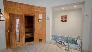 a bathroom with a wooden door and a tub in it at Gemma Resort in Marsa Alam City