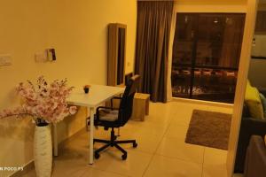 a room with a table and a chair and a window at HA206 - WI-FI- NETFLIX-PARKING- SWIMMING POOL- CYBERJAYa, 3073 in Cyberjaya