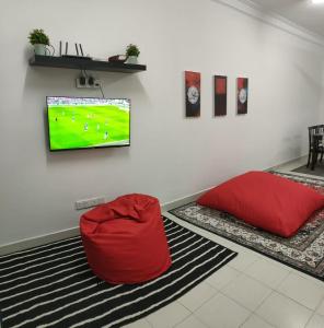 a room with two bean bags and a tv on a wall at Two Bed Rooms -Cahaya Homestay Tanjung Malim in Ulu Bernam