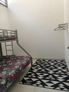 a bedroom with a bunk bed and a black and white rug at Two Bed Rooms -Cahaya Homestay Tanjung Malim in Ulu Bernam