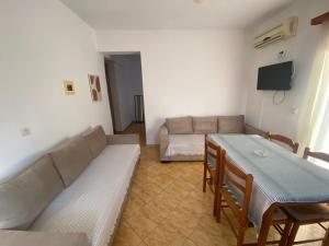 a living room with a couch and a table at Vila Tani in Ksamil