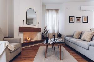 a living room with a couch and a fireplace at The Repose Aesthetic Apt. R2 in Heraklio Town