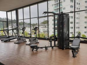 a gym with a bunch of tread machines in a building at ForestNest Cameron Town Spacious 3R3B (1300 sqft) in Tanah Rata