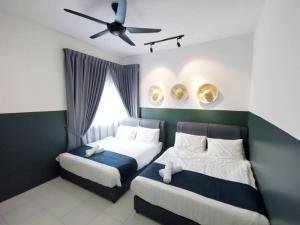 a bedroom with two beds and a ceiling fan at ForestNest Cameron Town Spacious 3R3B (1300 sqft) in Tanah Rata