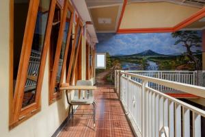 a balcony with a mural on the wall at RedDoorz near Desa Wisata Tambi Dieng in Wonosobo