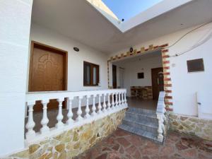 a staircase in a house with a wooden door at Vila Tani in Ksamil