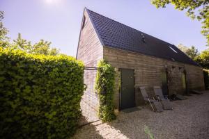 a brick building with two chairs and a fence at Wonderful 50m2 Loft Eindhoven - KS8 in Eindhoven