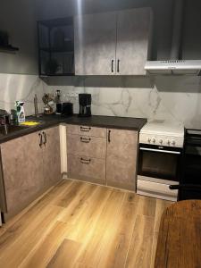 a kitchen with stainless steel appliances and wooden floors at Deluxe Center Apartment - Preveza in Preveza +28 photos