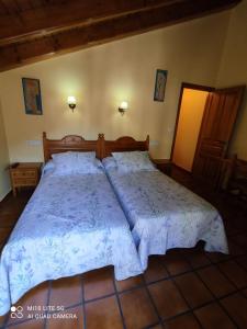 a bedroom with a large bed in a room at Casa A Ruata in Torla-Ordesa