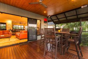 an open deck with a table and chairs at Asrama Broome in Broome