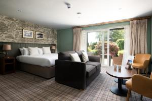 a hotel room with a bed and a couch at Wateredge Inn- The Inn Collection Group in Ambleside