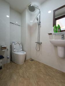 a bathroom with a toilet and a sink at Best Studio Room Near Ben Thanh Market in Ho Chi Minh City