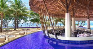 a resort with a swimming pool and a beach at SO/ Sofitel Mauritius in Bel Ombre