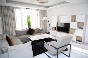 a living room with a couch and a table at White Stone Apartments Nyarutarama in Kigali