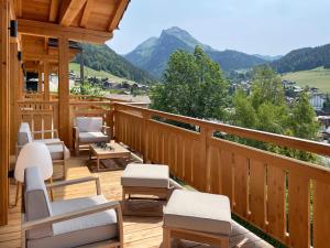 a deck with chairs and a view of a mountain at Chalet Tilly in Morzine
