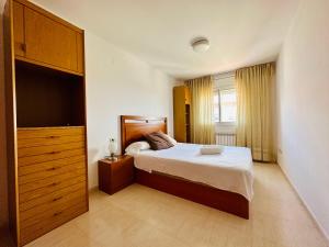 1 dormitorio con 1 cama, vestidor y armario en BOOK VILA-SECA TOWN, en Vila-seca