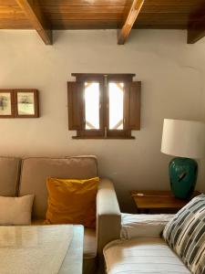 a living room with a couch and a window at La Casita in Fuente del Oro