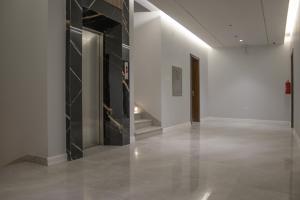 a hallway with a large glass wall in a museum at سمت للشقق المخدومة السلام in Riyadh