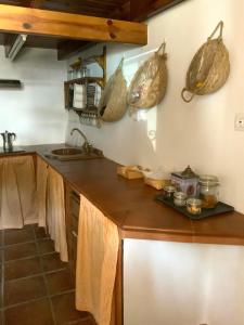a kitchen with a counter with baskets on the wall at La Casita in Fuente del Oro