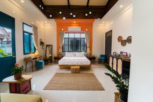 a bedroom with a bed in the middle of a room at Baan Pila in Luang Prabang +180 photos
