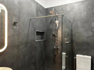 a shower with a glass door in a bathroom at Deluxe Center Apartment - Preveza in Preveza