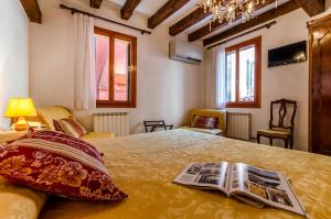 a bedroom with a bed with a newspaper on it at Hotel Ariel Silva in Venice
