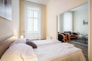 a bedroom with a large bed with a mirror on the wall at Pyvo Street Home with balcony near the Danube in Budapest