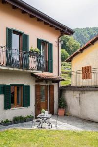 a patio with a table in front of a house at LEONI Apartment - charming full home in Bellagio in Bellagio