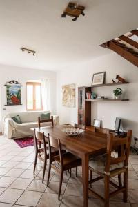 a living room with a wooden table and chairs at LEONI Apartment Bellagio in Bellagio