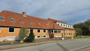 a large brick building on the side of a street at Gudum Park in Lemvig