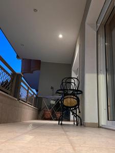 a chair sitting on the balcony of a house at CW Flat in Alexandroupoli