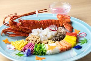 a plate of food with a lobster and other foods at Hatago in Kobe