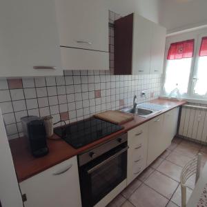 a kitchen with a sink and a stove top oven at Attico Centrale Ostia 20 in Lido di Ostia
