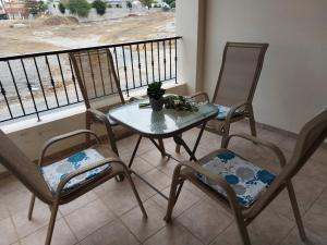 a table and two chairs on a balcony with a table and chairs at Pyla Palms Resorts A2 102 in Pyla