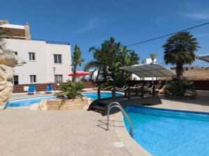 a resort with a swimming pool and a building at Pyla Palms Resorts A2 102 in Pyla